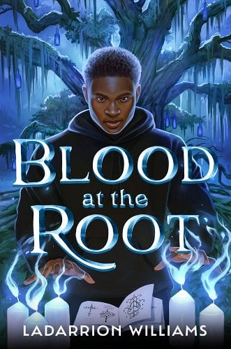 The cover of Blood at the Root, illustrated by Hillary D Wilson. A young Black man in a black hoodie stands in front of a large tree in a foggy, nighttime landscape. He holds his palms poised over an open book and candles emitting eerie blue flames.