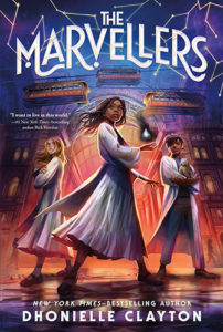 The cover of The Marvellers, illustrated by Khadijah Khatib. A Black girl with her hair in box braids wearing a white cloak stands confidently in the middle of the cover, shadowy magic hovering over her upheld hand. A blonde white girl and a Black boy with dreadlocks holding a small furry animal in his arms, both in white cloaks, stand behind the Black girl. The trio form a triangle in front of a large building with tram cars traveling on cords overhead.